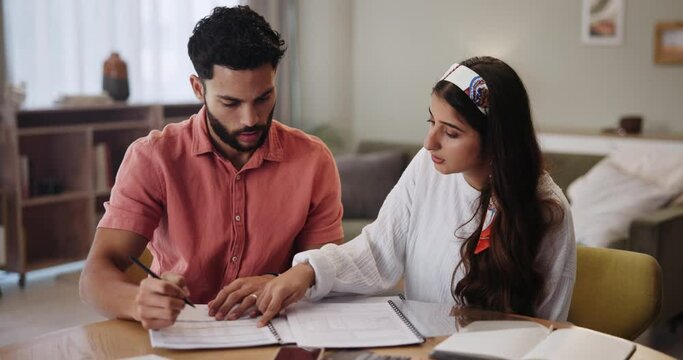Table, home and couple with documents in discussion for bills, finance planning and investment together. Man, woman and paperwork with communication in house for mortgage, debt and review of budget