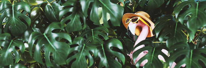 Pink flamingo wearing hat and sunglasses hidden in Monstera leaves. Summer tropical concept background. 3D Rendering, 3D Illustration