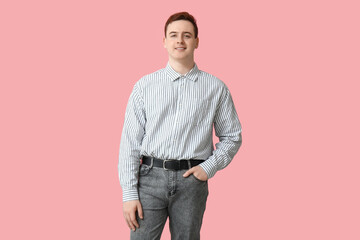 Handsome young man in stylish striped collar shirt on pink background