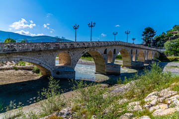 Fototapeta premium A view along the side of the Gorica bridge in Berat, Albania in summertime