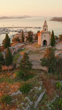 Picturesque St. Nicholas church and the old town of Tribunj on a small island in Adriatic sea, Dalmatia region of Croatia. Beautiful aerial view of the medieval Croatian Tribunj town