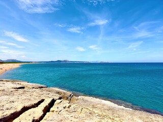view from a stone cliff along the long beaches Platja de Racó and Platja de Pals between Pals and...