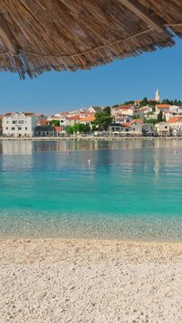 Idyllic beach near the charming Primosten town, Adriatic Sea in Croatia. A perfect summer holidays travel destination.