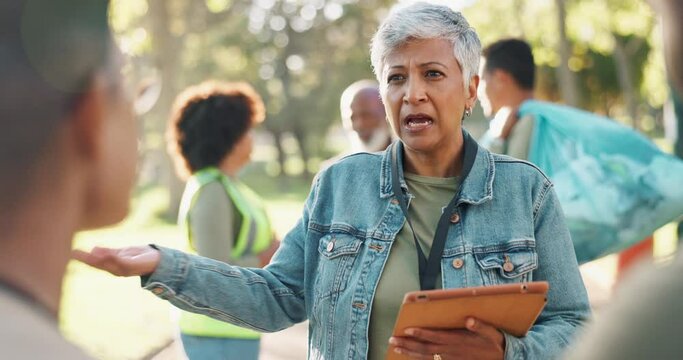Park, mature woman or volunteers talking for support, community project or plastic for nature sustainability. Humanitarian, recycling or leader speaking of checklist, charity service or NGO together