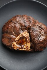 Piece of tasty grilled beef meat on plate, top view