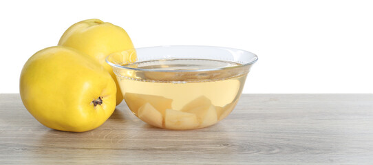 Delicious quince drink and fresh fruits on wooden table against white background