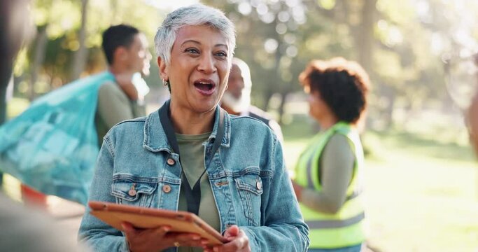 Charity, tablet or mature woman with team in forest for thank you, conversation or donation gratitude. Earth day, ngo or manager with digital, app or checklist for community service volunteer sign up