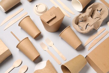 Eco friendly food packaging. Paper containers and tableware on light grey background, above view