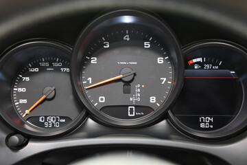 Speedometer and tachometer inside of modern car, closeup