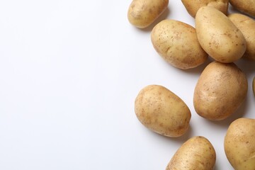 Fresh raw potatoes on white background, flat lay. Space for text