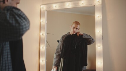 Young Gay Man Contemplating Gender Expression in Clothing Choice