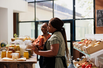 Black woman with spectacles shopping in zero waste store looking for farm grown bulk products....