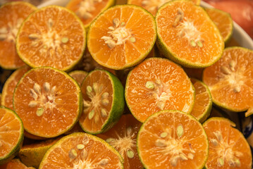 Tangerines cut in half to prepare natural juice