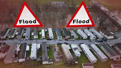 Aerial of a flooded mobile home park with graphic of large Flood signs. Caution, flood, natural...