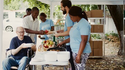Group dedicated to charity helping out the poor giving away free food including fresh fruits to...