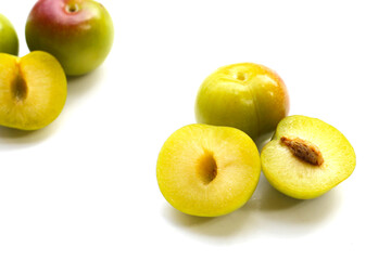 Fresh green plum fruit on white background.