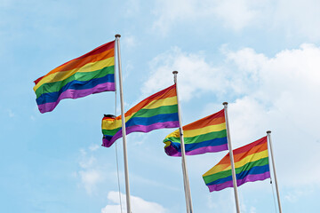 Rainbow flags, Flag for LGBT, LGBTQ or LGBTQIA+ Pride, The rainbow LGBTQ flags flies in the blue sky