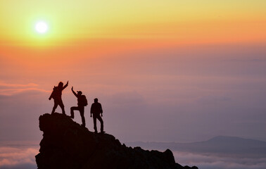 The Team Welcoming the Sunrise at the Summit