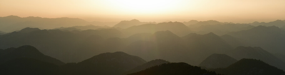 The Sun Rising Behind the Mountains
