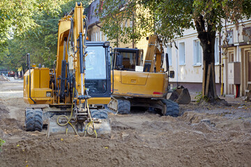 Two excavators on a construction site for road repair work. Excavation work before laying asphalt...