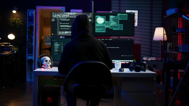 Experienced hacker writing lines of code on computer from underground bunker, tying to get past security systems. Rogue programmer building scripts that can hack devices, camera B