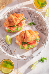 Golden and healthy french croissant with fish and avocado.