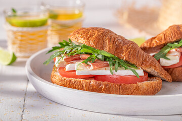 Delicious french croissant made of ham, cheese and vegetables.