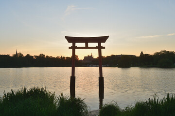 Metz, France. Torii gates mark the transition from the human world to the sacred space of Shinto shrines in Japan and the cathedral (Cathédrale Saint-Etienne de Metz) at sunrise. May 10, 2024.