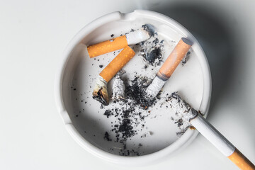 Ashtray with cigarette butts isolated on a white background