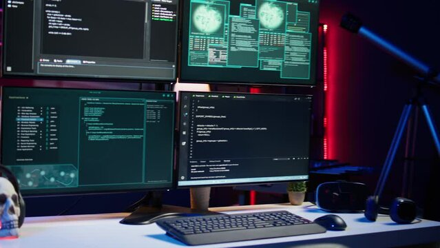 Close up of code running on computer displays in empty apartment used by hacker stealing secrets. Illegal scripts on PC screens used by spy infiltrating governments, handheld camera shot