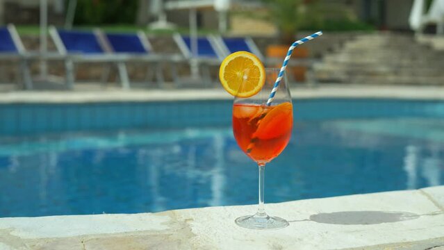 Cold and refreshing aperol spritz cocktail is the perfect summer drink at poolside. Holiday vacation.