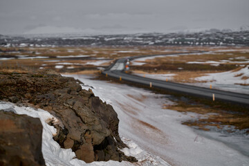 View of rock and snow with blur background and road in iceland