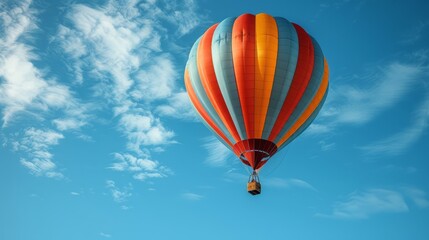 Fototapeta premium Vibrant hot air balloon floating in a clear blue sky with fluffy white clouds.