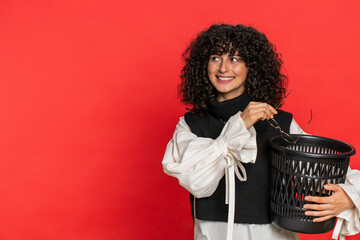 Caucasian young woman with curly hair taking off throwing out glasses into bin after medical vision...