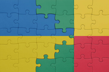 puzzle with the colourful national flag of benin and flag of ukraine.