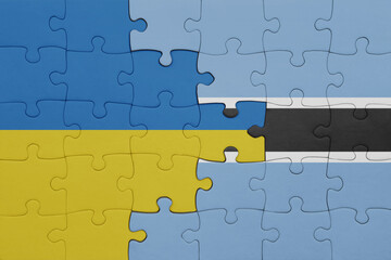 puzzle with the colourful national flag of botswana and flag of ukraine.