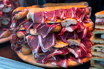 Bocadillos with ham on showcase of Spanish fast food cafe