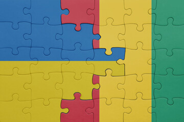 puzzle with the colourful national flag of guinea and flag of ukraine.