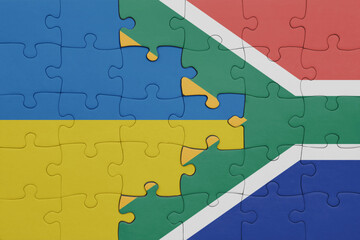 puzzle with the colourful national flag of south africa and flag of ukraine.