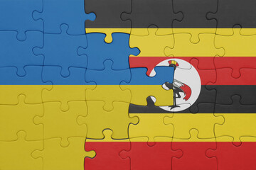 puzzle with the colourful national flag of uganda and flag of ukraine.