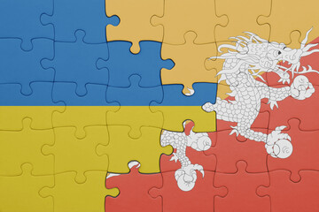 puzzle with the colourful national flag of bhutan and flag of ukraine.