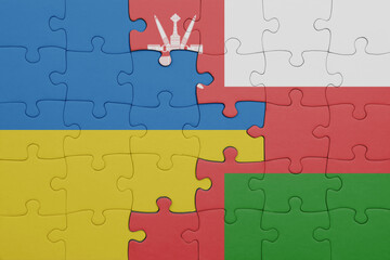 puzzle with the colourful national flag of oman and flag of ukraine.