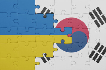 puzzle with the colourful national flag of south korea and flag of ukraine.