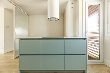 A modern kitchen includes at least a stove, a sink and refrigerator, and storage furniture