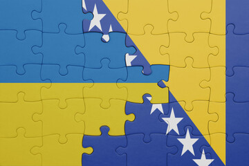 puzzle with the colourful national flag of bosnia and herzegovina and flag of ukraine.