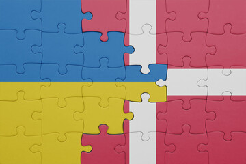 puzzle with the colourful national flag of denmark and flag of ukraine.