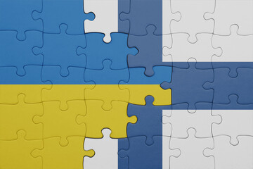 puzzle with the colourful national flag of finland and flag of ukraine.