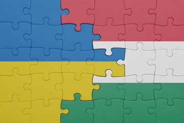 Fototapeta premium puzzle with the colourful national flag of hungary and flag of ukraine.