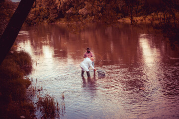 Portrait of cheerful senior man fishing. Grandfather and son fishermans. Young man and an old man...