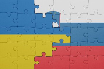 puzzle with the colourful national flag of slovenia and flag of ukraine.